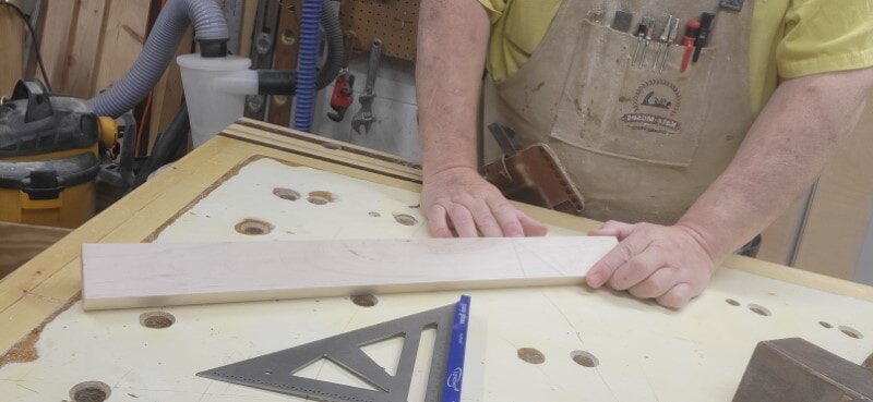 Showing a marked board with layout lines Board showing a square layout line and intersecting 45-degree angle for beginner woodworking