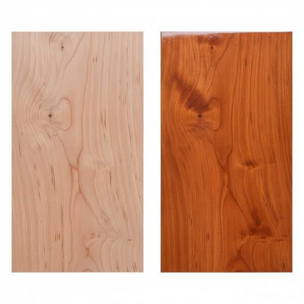 Cherry wood board shown unfinished on the left and coated with oil-based polyurethane on the right, highlighting the warm reddish-brown tone and grain pattern.