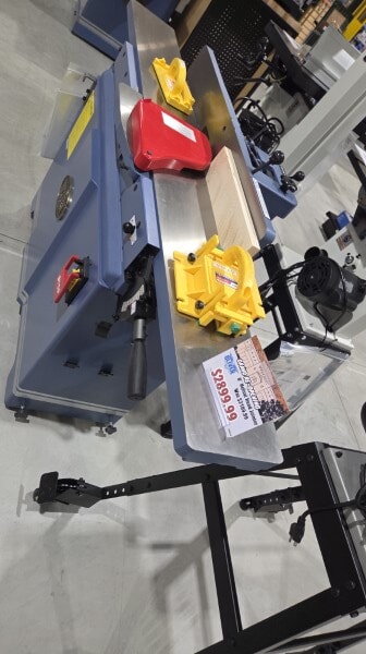 Oliver 8-inch jointer on display at Woodcraft with yellow push blocks and a sample board on the table.