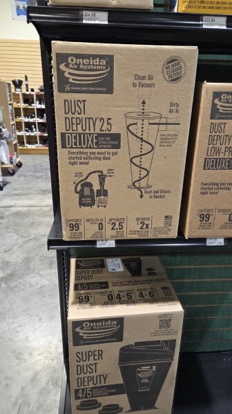 Boxes of the Oneida Dust Deputy 2.5 Deluxe cyclone separator on display at Woodcraft.