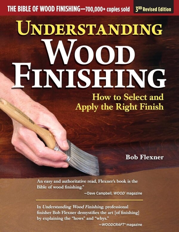 Cover of Understanding Wood Finishing by Bob Flexner, showing a hand applying finish with a brush and featuring review quotes.